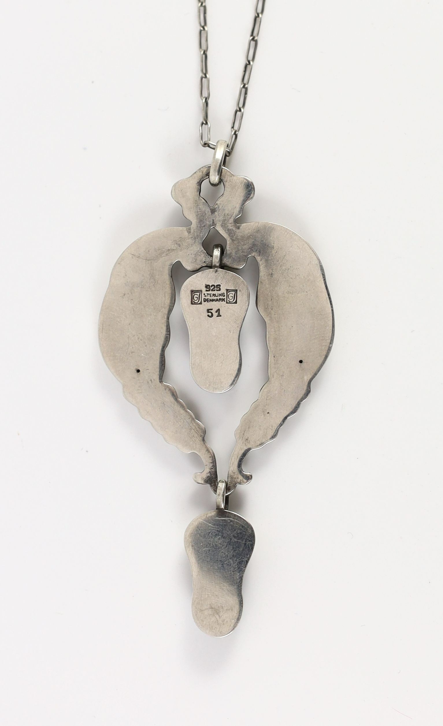 A 1920's George Jensen sterling silver and two stone lapis lazuli set drop pendant, design no. 51